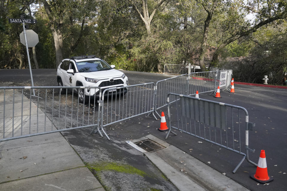 Barricades block the street near the family home of FTX founder Sam Bankman-Fried in Palo Alto, Calif., Friday, Dec. 23, 2022. Bankman-Fried's parents agreed to sign a $250 million bond and keep him at their California home while he awaits trial on charges that he swindled investors and looted customer deposits on his FTX trading platform. (AP Photo/Jeff Chiu)