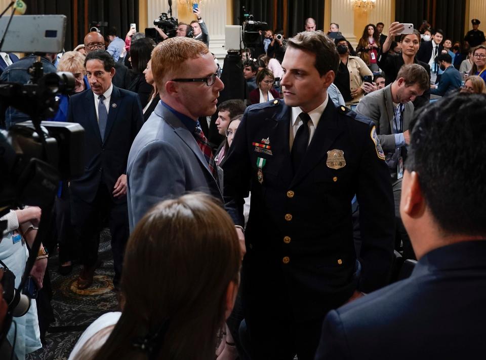 Stephen Ayres, left, apologizes to two law enforcement officers who defended the U.S. Capitol on Jan. 6, 2021, after Ayres completed his testimony Tuesday before the House Select Committee investigating the attack.