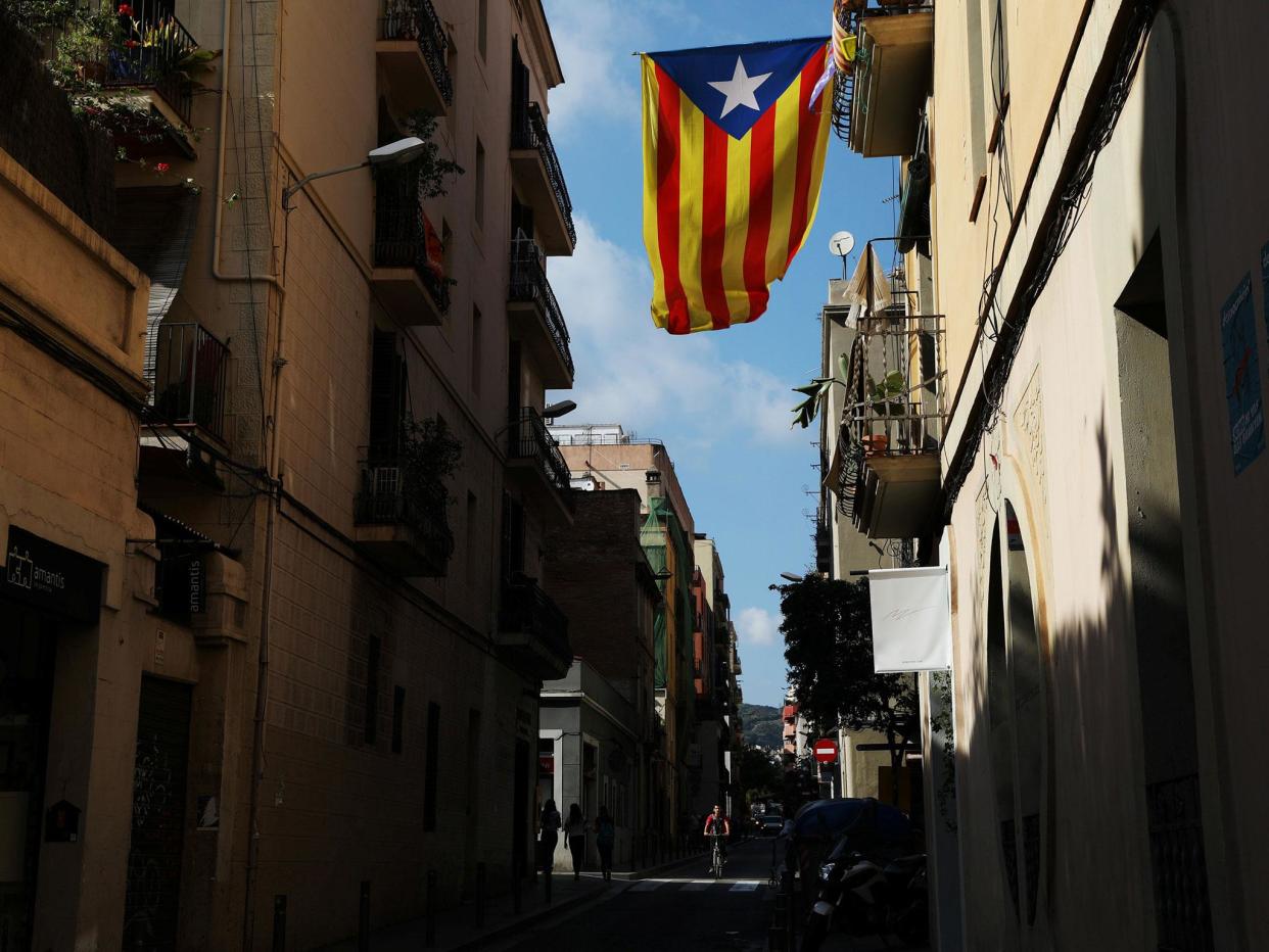 A Catalan separatist flag hangs from a balcony in Barcelona: Reuters