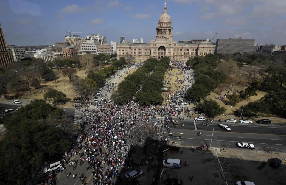 A women's march heads to the Texas State Capitol in Austin, Texas (AP)