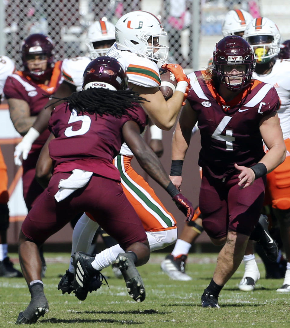 Miami's Will Mallory (85) is hit by Virginia Tech's Nasir Peoples (5) during the first half during the first half of an NCAA football game, Saturday Oct. 15 2022, in Blacksburg Va. Peoples was called for targeting on the play and was ejected, (Matt Gentry/The Roanoke Times via AP)