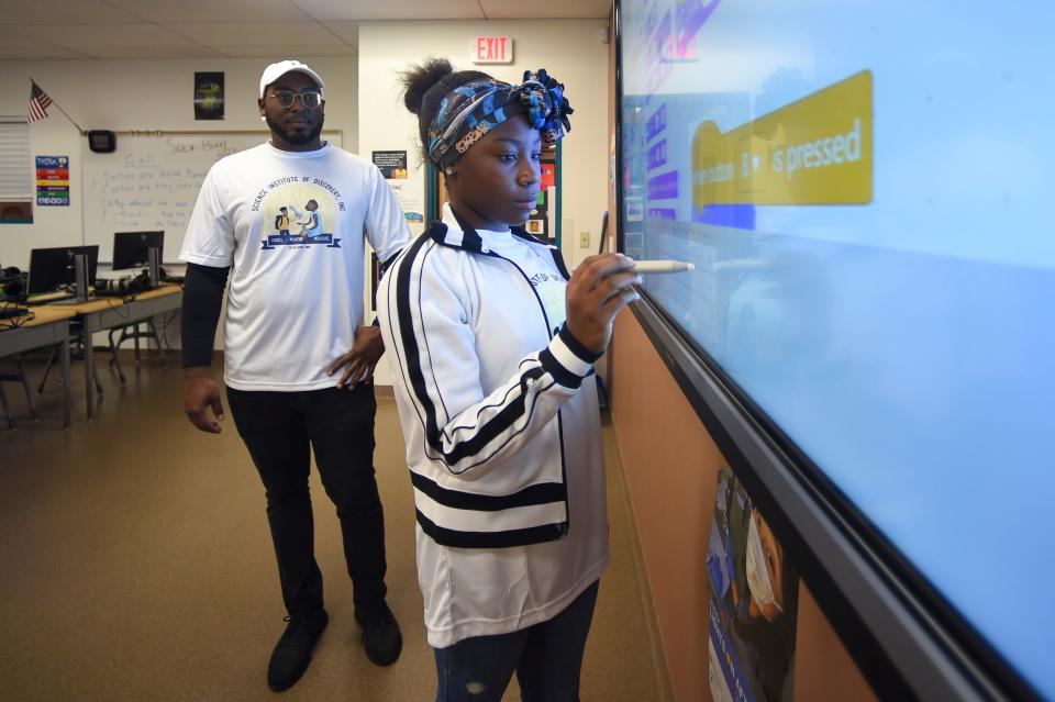 George Ingram and Ahjiah Greene, 11, program a robot during a "Living in Space, Preparing on Earth" science fair, Wednesday, July 6, 2022, prior to linking with the space station to hear from astronauts Jessica Watkins and Robert Hines. "This program introduces fundamental concepts of computer science," Ingram said. The program prepares students for the world they are entering, where they can apply what they've learned to real-life scenarios. After the science fair, students of the Science Institute of Discovery summer camp at the Gifford Youth Achievement Center participated in a question-and-answer session with astronauts from the International Space Station.