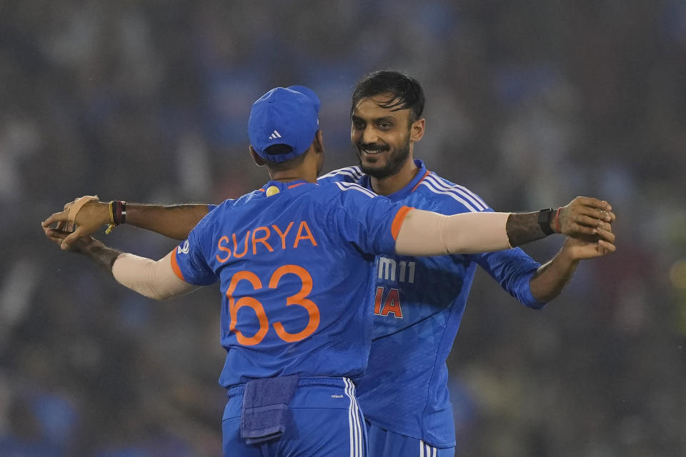 India's Axar Patel celebrates the dismissal of Australia's Ben McDermott with India's captain Suryakumar Yadav during the fourth T20 cricket match between Australia and India in Raipur, India, Friday, Dec. 1, 2023. (AP Photo/Mahesh Kumar A.)