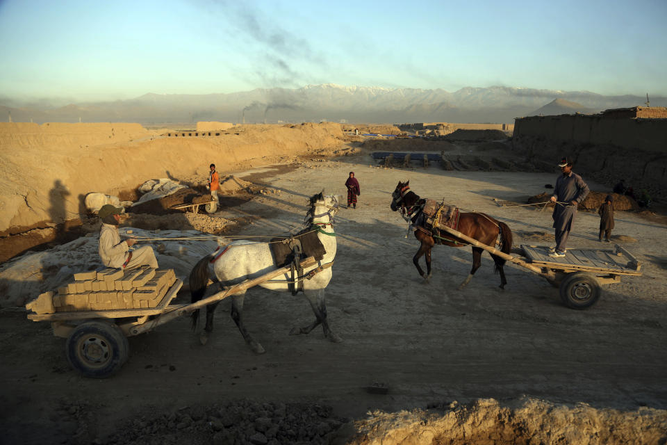 In this Wednesday, June 19, 2019, photo, Afghan day laborers work at a brick factory on the outskirts of Kabul, Afghanistan. The U.S. and its allies have sunk billions of dollars of aid into Afghanistan since the invasion to oust the Taliban 18 years ago, but the country remains mired in poverty. Signs of hardship are everywhere, from children begging in the streets to entire families _ including children as young as five or six _ working at brick kilns in the sweltering heat.(AP Photo/Rahmat Gul)