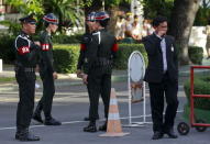 A man walks past military police officers before Thailand's Prime Minister Prayuth Chan-ocha arrives at the Education Ministry in Bangkok, Thailand, May 21, 2015. REUTERS/Chaiwat Subprasom