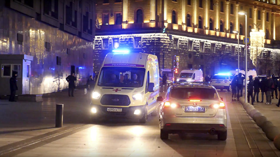 Ambulances leave the area near the building of the Federal Security Service (FSB, Soviet KGB successor) in the background in Moscow, Russia, Thursday, Dec. 19, 2019. Russian officials say an officer of Russia's main security agency has been killed by an unidentified gunman near its Moscow headquarters and five others have been injured. (AP Photo/Ilya Varlamov)