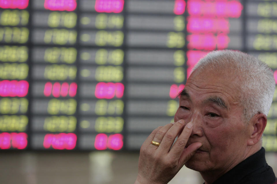 An investor gestures as he looks at the stock price monitor at a private securities company Tuesday May 15, 2012 in Shanghai, China. Asian stock markets were mostly lower Tuesday, rattled by a political impasse in Greece that could lead the debt-stricken country to a destabilizing exit from the euro currency union. (AP Photo)