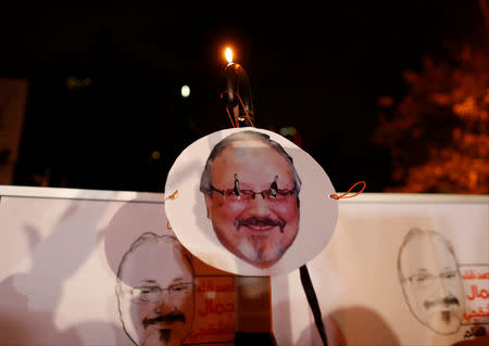 Demonstrators hold placards with a picture of Saudi journalist Jamal Khashoggi outside the Saudi Arabia consulate in Istanbul, Turkey October 25, 2018. REUTERS/Osman Orsal