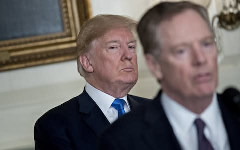 U.S. President Donald Trump listens as Robert Lighthizer, U.S. trade representative, right, speaks before Trump signs a presidential memorandum targeting China's economic aggression  - Credit: Bloomberg