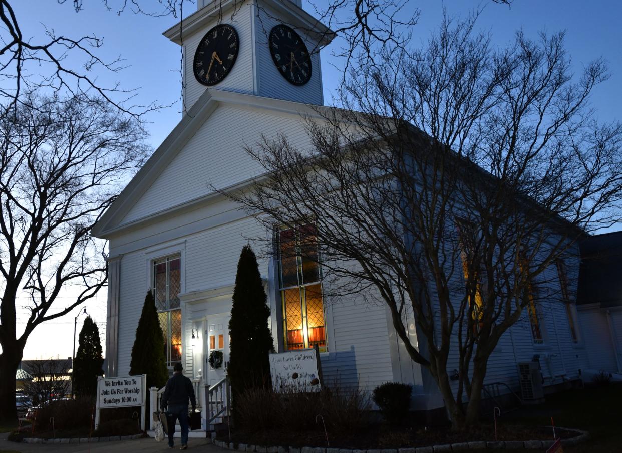 As the sun sets on the first night of winter musician Steve Gregory arrives early on Dec. 21 to set up for a Homeless Persons Memorial Service at the First Baptist Church of Hyannis.