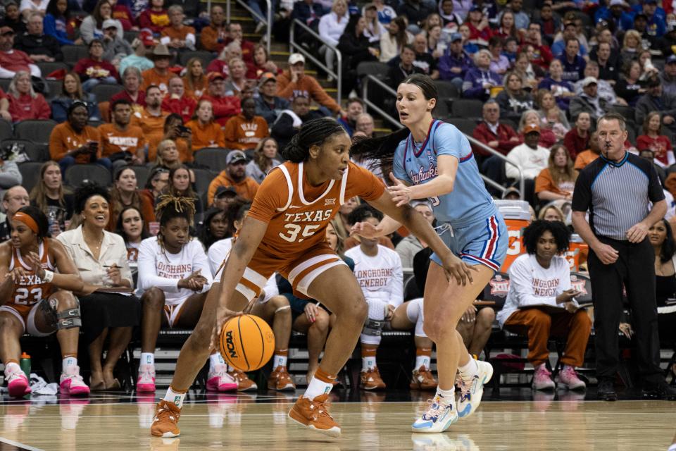 Texas point guard Madison Booker tries to get around Kansas guard Holly Kersgieter during the second half of the Longhorns' 76-60 win Saturday night. Texas will face Kansas State in Monday afternoon's Big 12 Tournament semifinals.