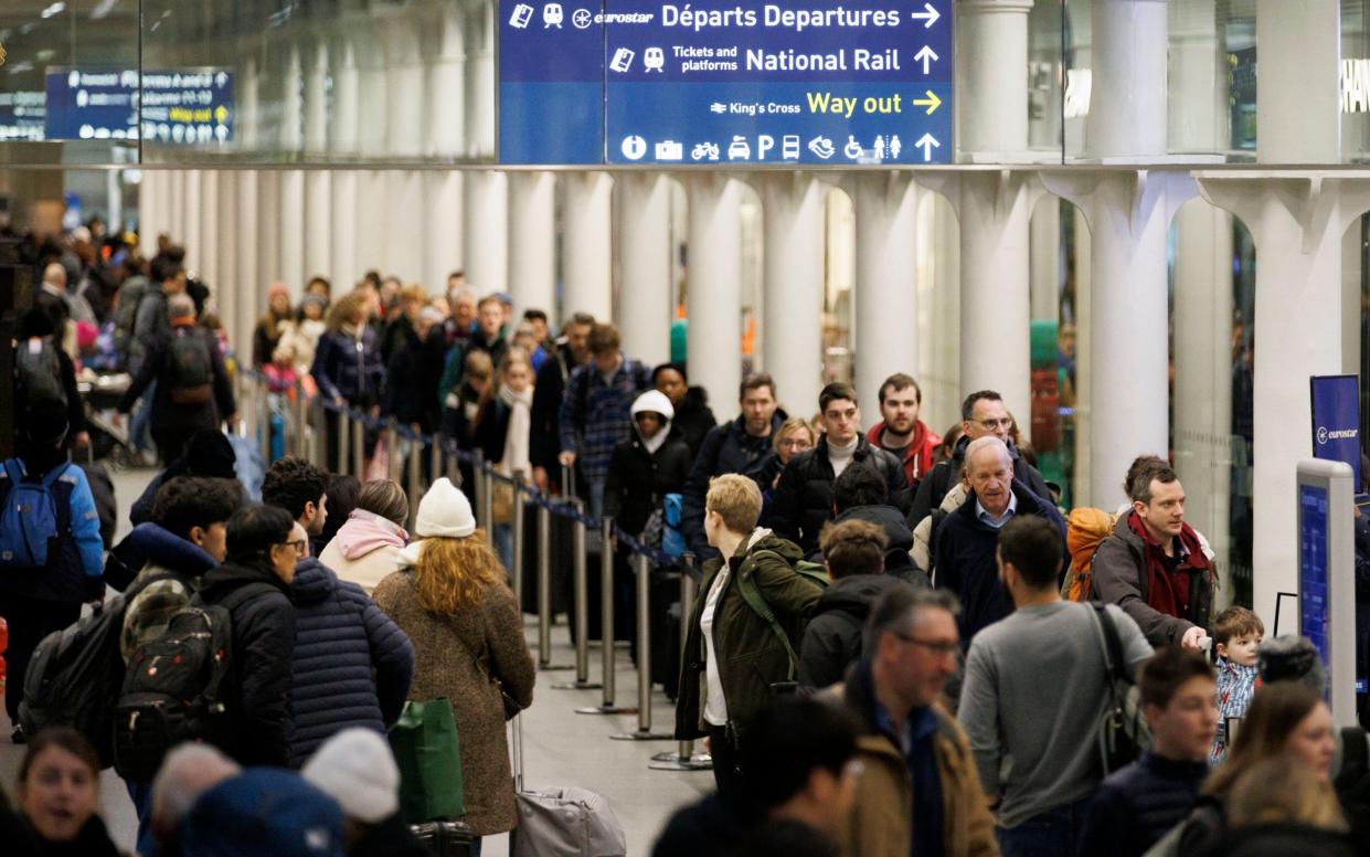 Passengers queue to board Eurostar trains at St Pancras International