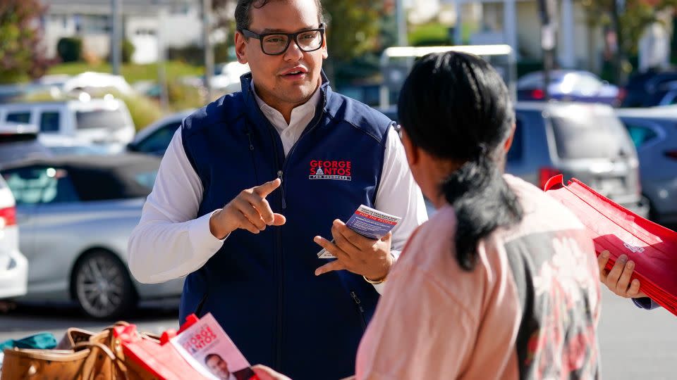 In this November 2022 photo, then-Republican candidate for New York's 3rd congressional district George Santos, talks to a voter while campaigning outside a Stop and Shop store in Glen Cove, New York. - Mary Altaffer/AP