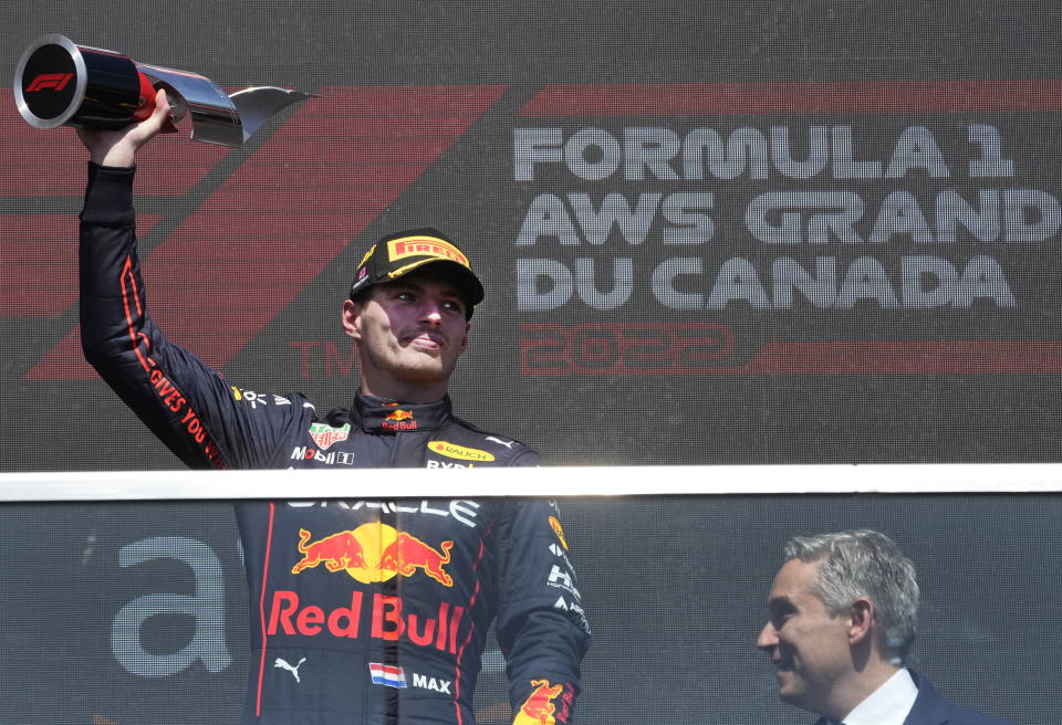 Red Bull Racing's Max Verstappen, left, of the Netherlands, celebrates after winning the Canadian Grand Prix auto race Sunday, June 19, 2022, in Montreal. (Ryan Remiorz/The Canadian Press via AP)