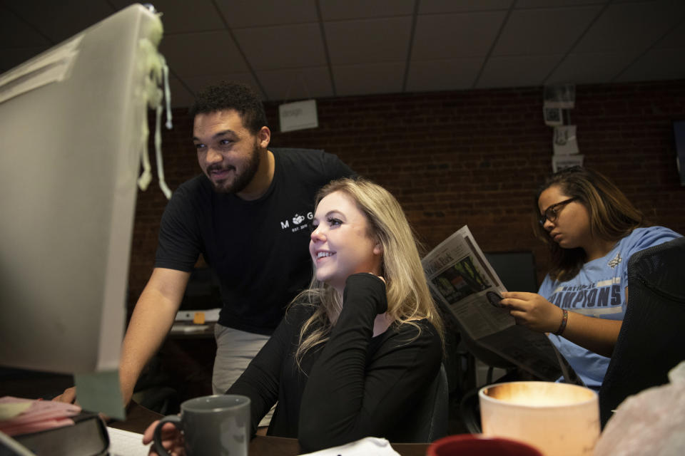 This Oct. 29, 2019 photo shows Editor-in-Chief Maddy Arrowood, a senior journalism and American history major, center, Copy Chief Brandon Standley, a junior advertising and psychology major, left, and Photo Co-Editor Maya Carter, a senior psychology and English major, at the office of The Daily Tar Heel, the independent student newspaper of the University of North Carolina in Chapel Hill, N.C. Thousands of young journalists train for the future on a dual track, in classrooms and in student-run newsrooms that are models for the places they hope to work someday. (Dustin Duong/The Daily Tar Heel via AP)