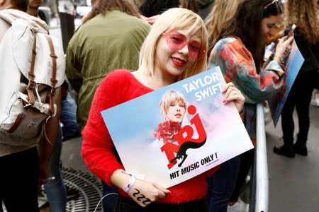 Fans of Taylor Swift wait in line to enter the Olympia Theatre prior to her concert performance in Paris
