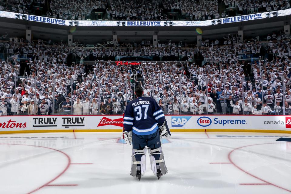 Goaltender Connor Hellebuyck gazes at the crowd ahead of a first-round playoff game in Winnipeg last year. (Jonathan Kozub/NHLI via Getty Images)