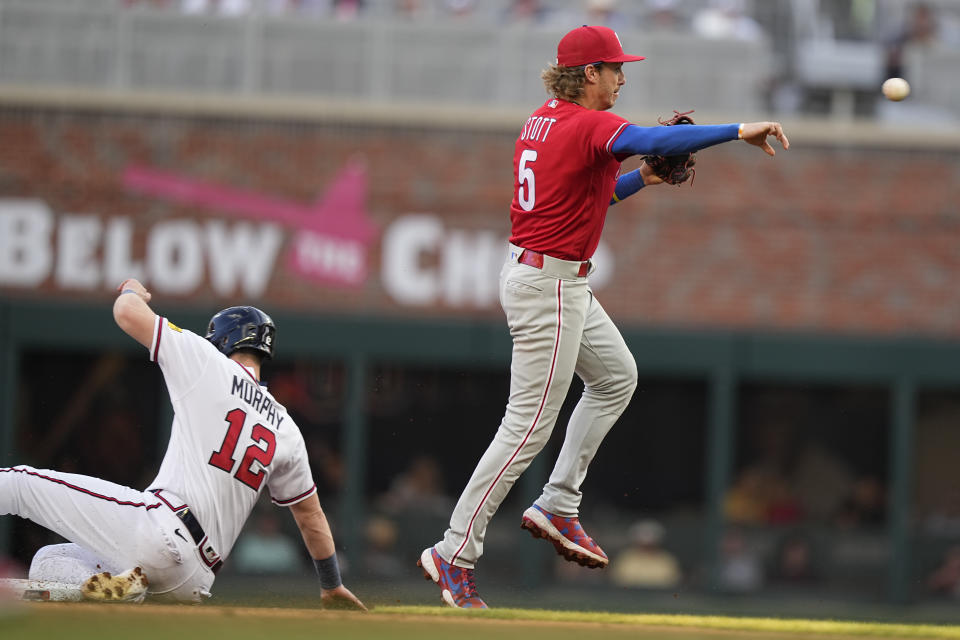 Philadelphia Phillies second baseman Bryson Stott (5) forces out Atlanta Braves' Sean Murphy (12) in a double play in the first inning of a baseball game, Sunday, May 28, 2023, in Atlanta. (AP Photo/Brynn Anderson)