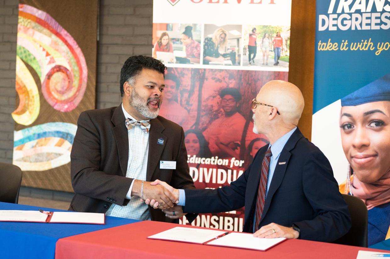 Kellogg Community College president Paul Watson and University of Olivet president Steven Corey sign a transfer agreement between the two institutions at Kellogg Community College on Wednesday, Oct. 18, 2023.
