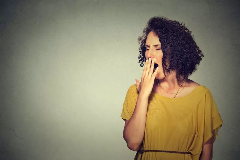 Thinkstock generic image of sleepy woman with wide open mouth yawning looking bored.   It is too early for meeting. Closeup portrait sleepy young woman with wide open mouth yawning eyes closed looking bored isolated grey wall background. Face expression emotion body language