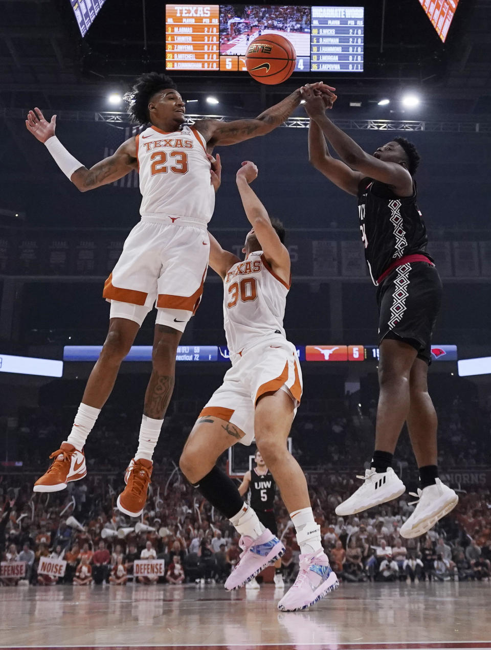 Texas forward Dillon Mitchell (23) blocks Incarnate Word center Josh Akpovwa during the first half of an NCAA college basketball game, Monday, Nov. 6, 2023, in Austin, Texas. (AP Photo/Eric Gay)