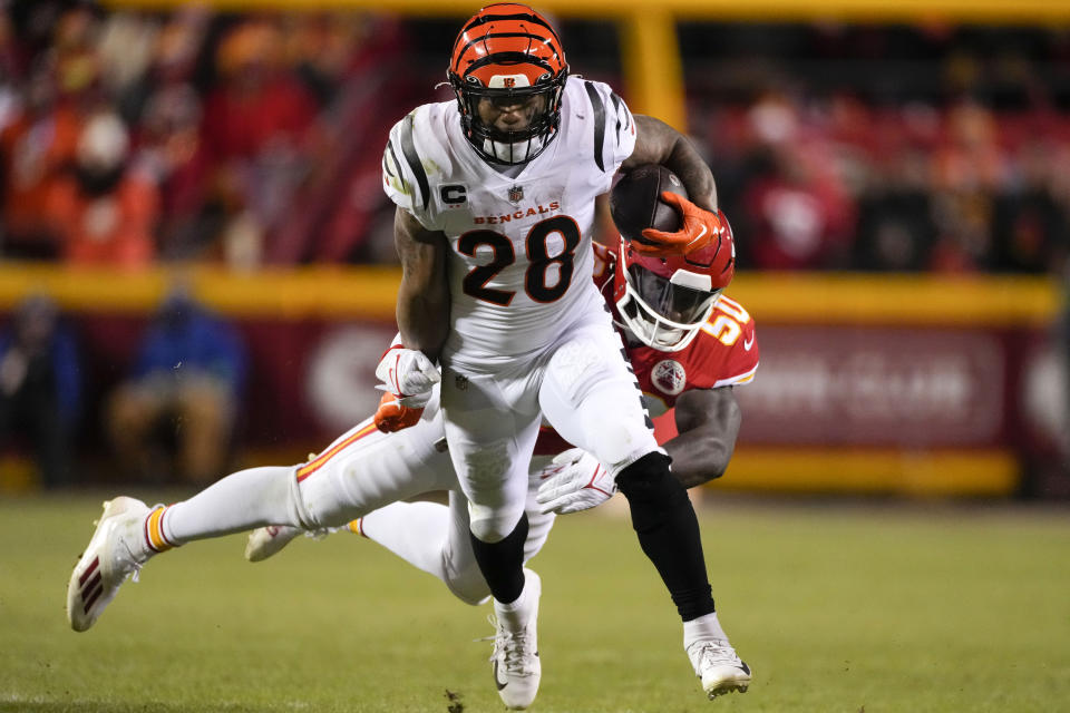 Cincinnati Bengals running back Joe Mixon (28) runs against Kansas City Chiefs linebacker Willie Gay (50) during the second half of the NFL AFC Championship playoff football game, Sunday, Jan. 29, 2023, in Kansas City, Mo. (AP Photo/Jeff Roberson)