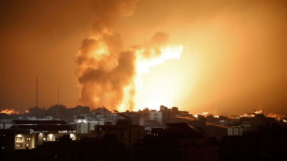 Fire and smoke rises above buildings during an Israeli air strike in Gaza City on October 8, 2023. - Eyad Baba/AFP/Getty Images