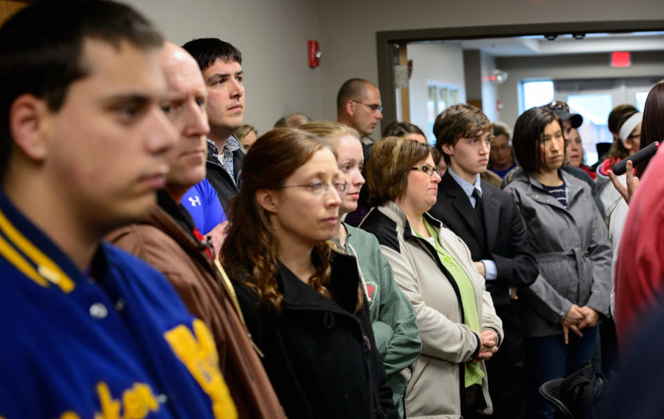 Students, parents and community members stand in the back of the room to listen as Waseca Police Captain Kris Markeson and Waseca school Superintendent Tom Lee speak at a news conference about the 17-year-old arrested in plot to kill family and massacre students at Waseca school. (AP Photo/The Star Tribune,Glen Stubbe)