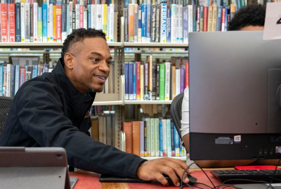 Daniel Mallory, a life coach with the Peacemakers program, works with a fellow Thursday, Sept. 7, 2023, at the Central Library in Indianapolis. The Indy Peace Fellowship aims to reduce gun violence by connecting high risk individuals with resources in the community.