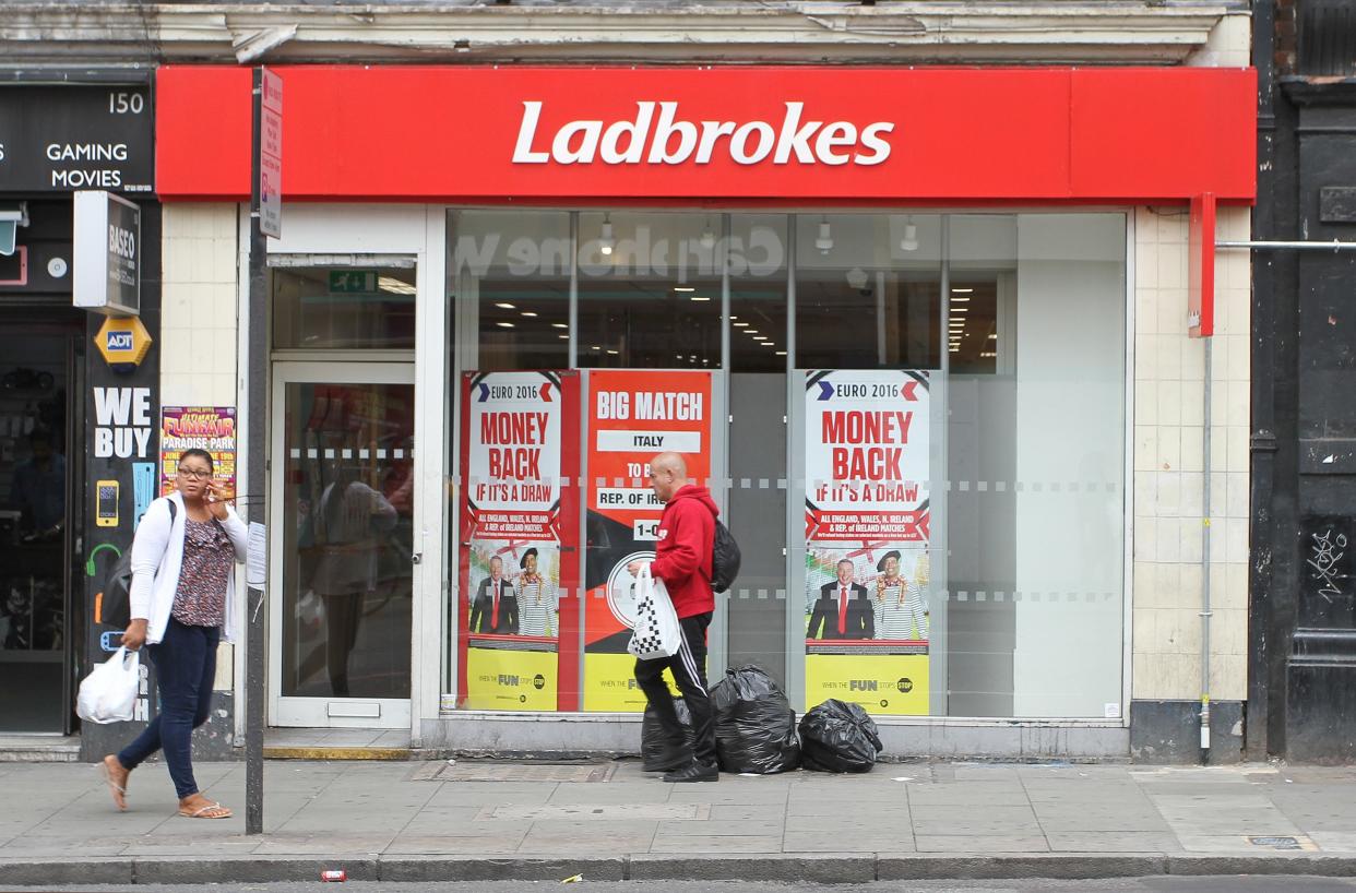 People walk past a Ladbrokes betting shop in London, Wednesday June 22, 2016. Thursday’s referendum on whether to leave the European Union, which could have lasting consequences for the country and Europe, is due to break the record as the most bet-upon political event in Britain’s history. (AP Photo/Leonora Beck)