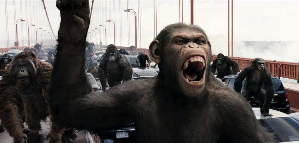 Apes standing on cars on a bridge in a scene from Rise of the Planet of the Apes