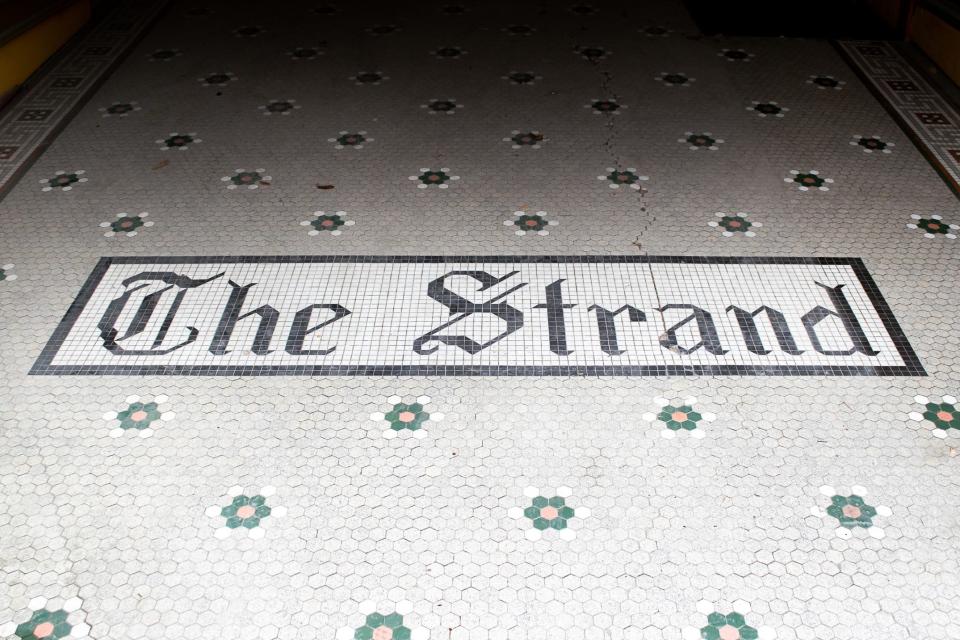 The tile walkway leading into the theater honors the buildings history, when it became The Strand in 1977, as well as home to the Cambridge Performing Arts Center.