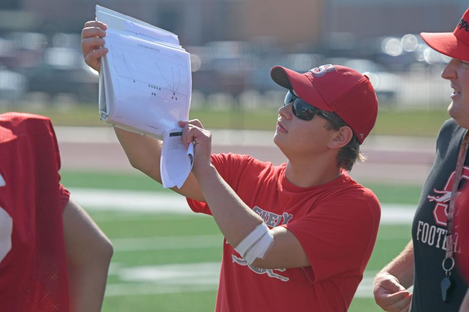 Alex Bushey helps relay the next play during Whippet practice.