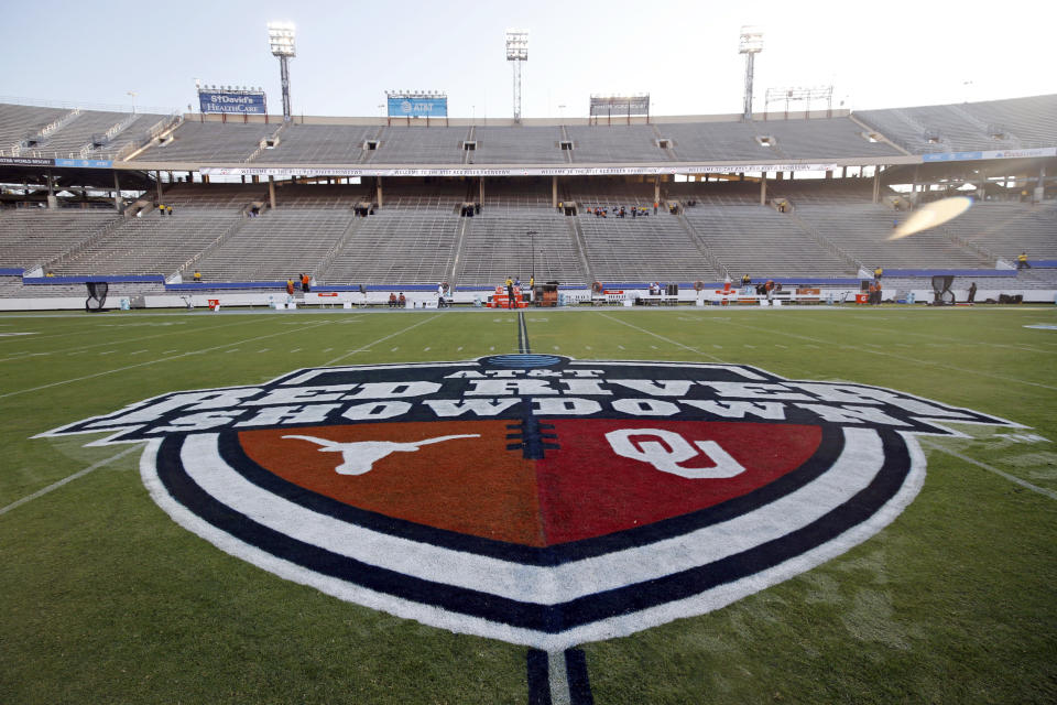 FILE - In this Oct. 10, 2020, file photo, The Red River Showdown logo is displayed on the field of the Cotton Bowl, prior to an NCAA college football game between the University of Texas and Oklahoma, in Dallas. Texas and Oklahoma made a request Tuesday, July 27, 2021, to join the Southeastern Conference — in 2025 —- with SEC Commissioner Greg Sankey saying the league would consider it in the “near future.” (AP Photo/Michael Ainsworth, File)