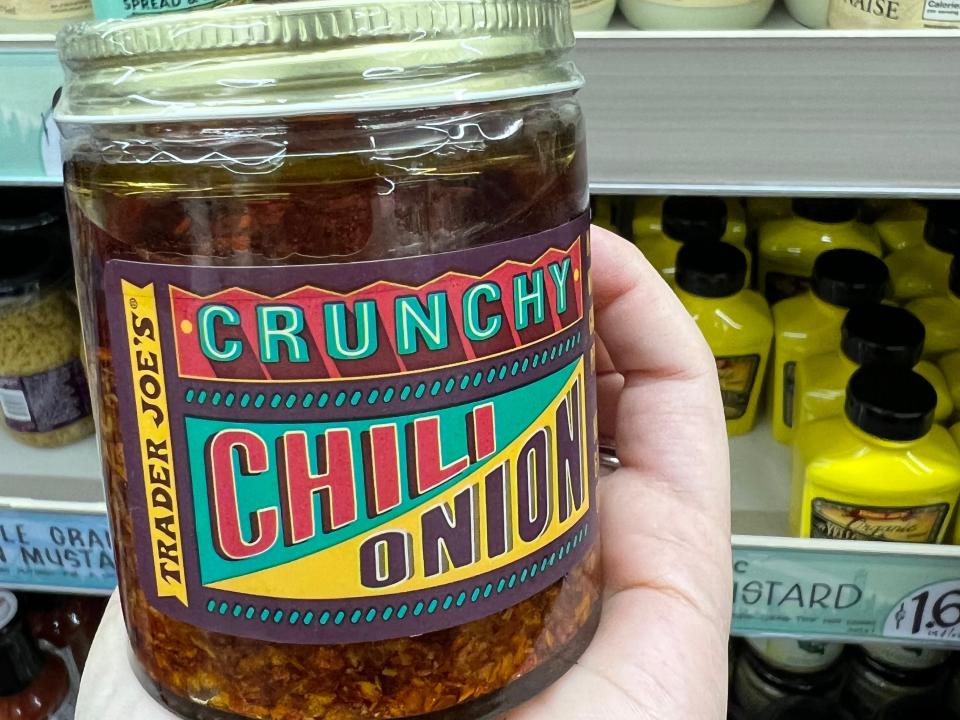 The writer holds a jar of Trader Joe's crunchy chili-onion oil