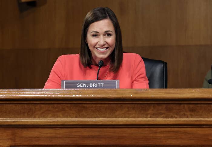 Smiling Britt sitting at a desk during a hearing