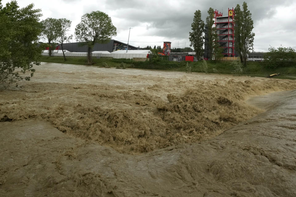 A view of the swollen Santerno River with behind the Enzo e Dino Ferrari circuit, in Imola, Italy, Wednesday, May 17, 2023. The weekend's Emilia-Romagna Grand Prix in Imola has been canceled because of deadly floods. Formula One said it made the decision for safety reasons and to avoid any extra burden on the emergency services. F1 personnel had earlier been told to stay away from the track after floods affected large parts of the Emilia-Romagna region. (AP Photo/Luca Bruno)