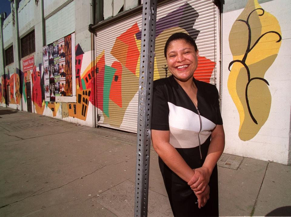 Karen Bass smiles on a sidewalk.