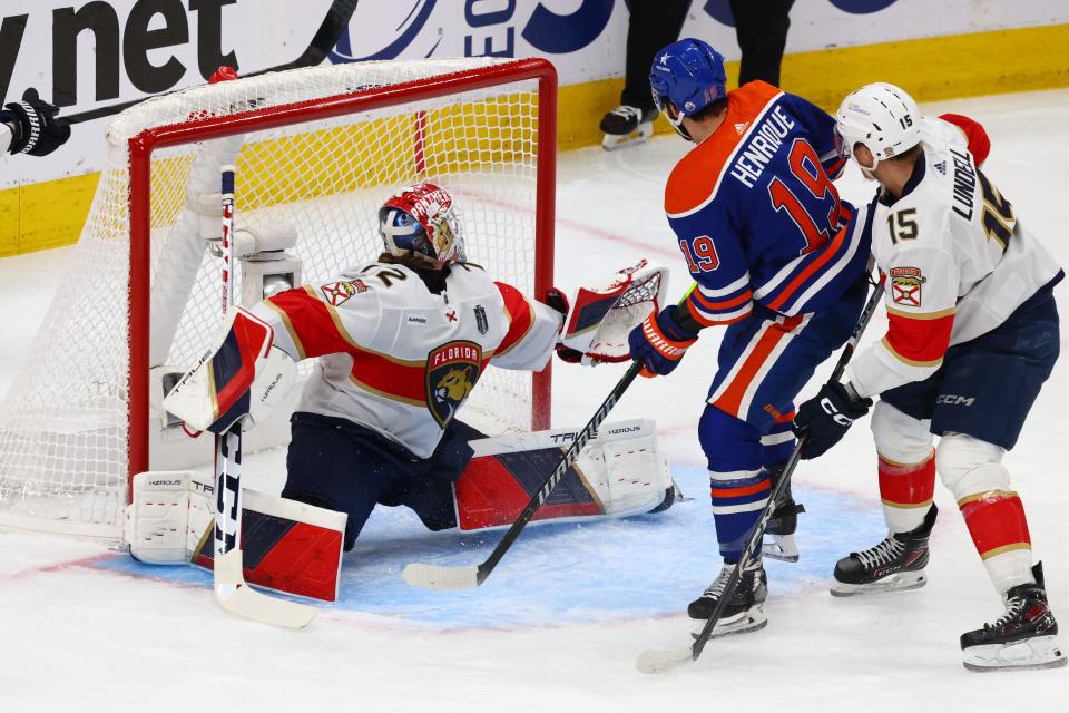 Jun 15, 2024; Edmonton, Alberta, CAN; Edmonton Oilers center Adam Henrique (19) scores a goal defended by Florida Panthers center Anton Lundell (15) and goaltender Sergei Bobrovsky (72) in the first period in game four of the 2024 Stanley Cup Final at Rogers Place. Mandatory Credit: Sergei Belski-USA TODAY Sports