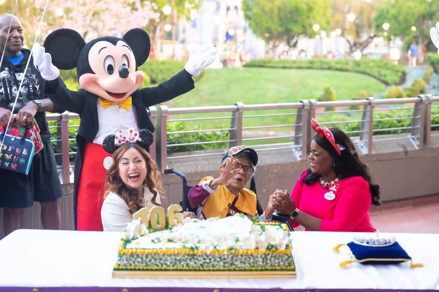 Magnolia Jackson, who wanted to celebrate her 106th birthday at Walt Disney World Resort in Lake Buena Vista, Fla., after seeing Mickey Mouse perform recently in his drum major uniform at a college football game, is warmly greeted Wednesday by Mickey Mouse and the Walt Disney World Ambassadors as she arrived at Magic Kingdom for the first time. Born March 14, 1918 and the oldest living graduate of Bethune-Cookman University in nearby Daytona Beach, Florida, Jackson was showered in birthday wishes and admiration by Disney cast members and executives before she went off to enjoy the parks, visiting with Princess Tiana and experiencing the EPCOT International Flower & Garden Festival. (Bennett Stoops, Photographer)