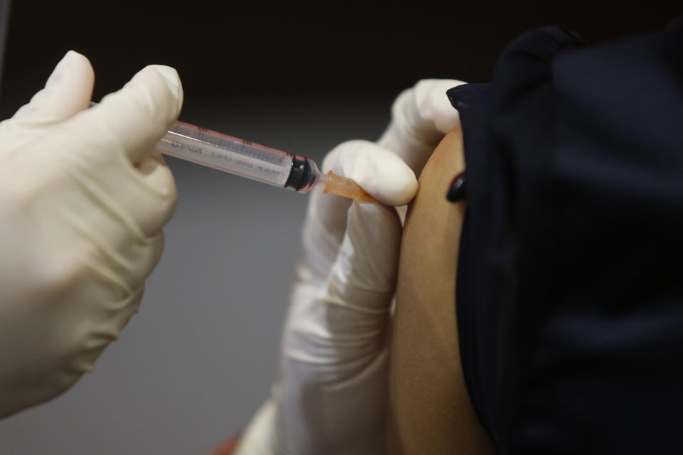 A health worker administers a dose of the Sinovac COVID-19 vaccine to a person in Bangkok, Thailand, Monday, May 17, 2021. Health authorities in Thailand on Monday reported 9,635 new confirmed cases of COVID-19, a new daily high that brought the cumulative total since January last year to 111,082. Almost three-quarters of all cases were recorded since April 1, when Thailand's third coronavirus wave began. (AP Photo/Anuthep Cheysakron)