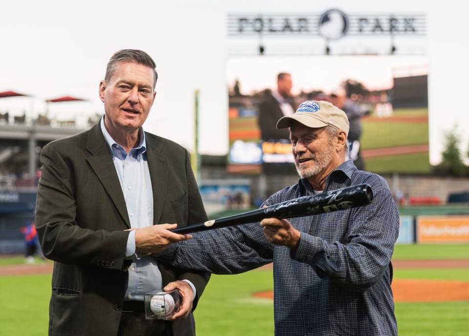 Former Worcester City Manager Edward M. Augustus Jr. is presented with a ceremonial bat by Worcester Red Sox chairman Larry Lucchino Sept. 22, 2022.