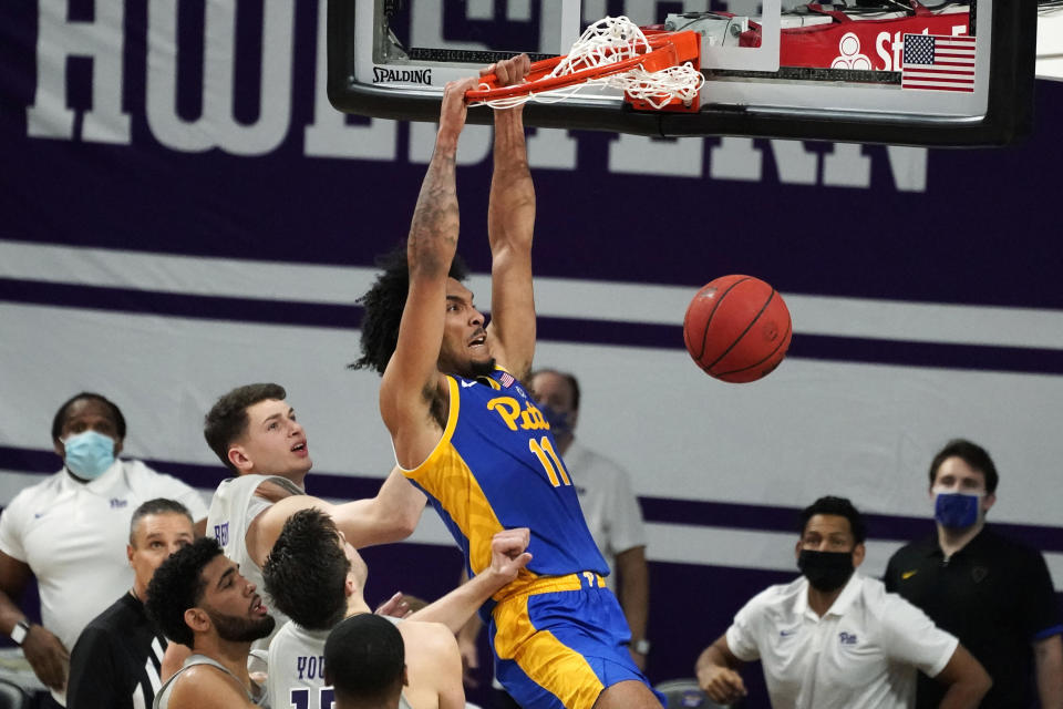 FILE - Pittsburgh's Justin Champagnie (11) dunks against Northwestern during the second half of an NCAA college basketball game in Evanston, Ill., in this Wednesday, Dec. 9, 2020, file photo. Champagnie is a member of The AP All-ACC first team, announced Tuesday, March 9, 2021. (AP Photo/Nam Y. Huh, File)