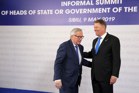 European Commission President Jean-Claude Juncker is welcomed by Romanian President Klaus Iohannis as he arrives for the informal meeting of European Union leaders in Sibiu, Romania, May 9, 2019. REUTERS/Stoyan Nenov