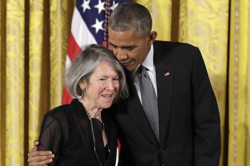 FILE - In this Thursday, Sept. 22, 2016 file photo, President Barack Obama embraces poet Louise Gluck before awarding her the 2015 National Humanities Medal during a ceremony in the East Room of the White House, in Washington. The 2020 Nobel Prize for literature has been awarded to American poet Louise Gluck "for her unmistakable poetic voice that with austere beauty makes individual existence universal." The prize was announced Thursday Oct. 8, 2020 in Stockholm by Mats Malm, the permanent secretary of the Swedish Academy. (AP Photo/Carolyn Kaster, File)