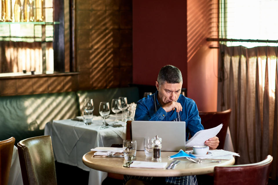 A restaurant owner working on his accounts