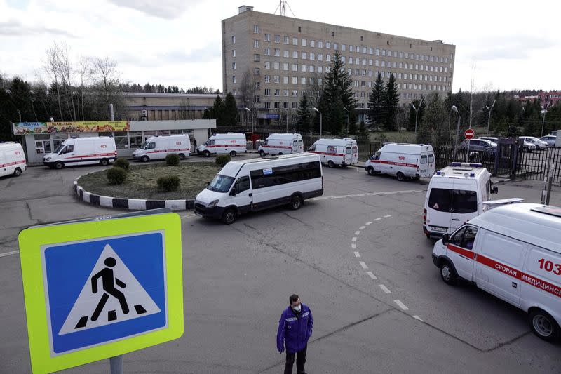 Ambulances queue before driving onto the adjacent territory of a local hospital in Khimki outside Moscow