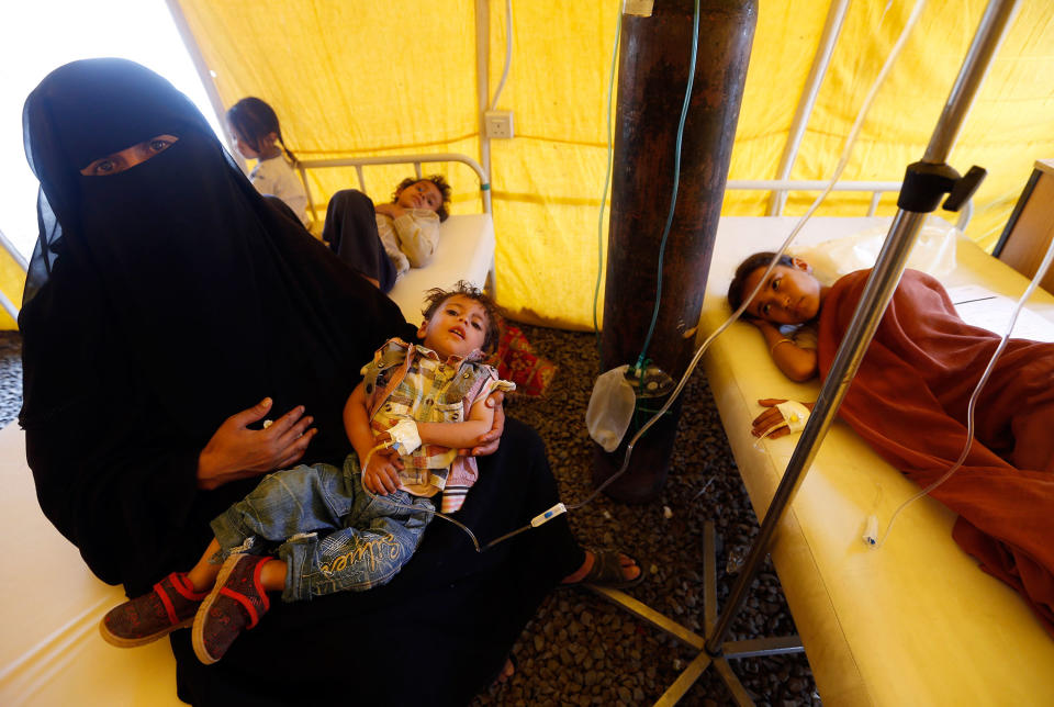 <p>Yemeni children suspected of being infected with cholera receive treatment at a makeshift hospital in Sana’a on June 5, 2017.<br> Yemen is descending into total collapse, its people facing war, famine and a deadly outbreak of cholera, as the world watches, the UN aid chief said. (AFP/Getty Images) </p>