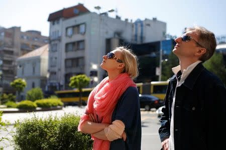 Russian ballet star Irina Kolesnikova and her husband Konstantin Tachkin stand outside the National Theatre in Belgrade, Serbia, April 21, 2016. REUTERS/Marko Djurica