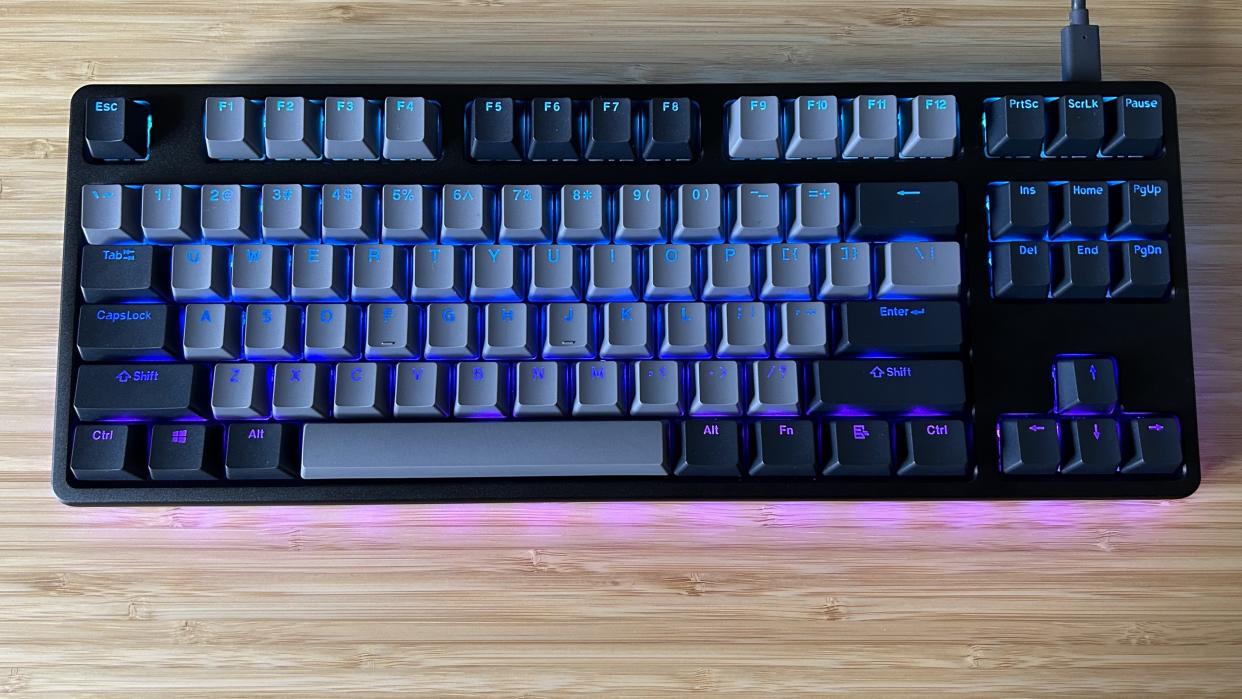  Drop CTRL V2 keyboard on a wooden desk. 